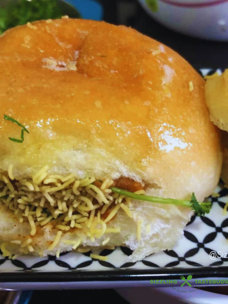 Dabeli is a spicy, tangy Indian street food from Gujarat, made with a flavorful potato filling, chutneys, crunchy peanuts, and pomegranate seeds, all stuffed in a buttery pav. It’s a delicious explosion of sweet, sour, and savory in every bite!