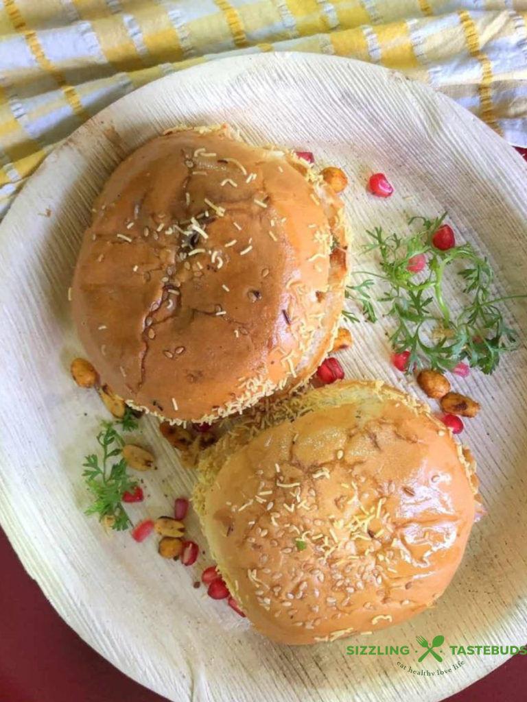 Dabeli is a spicy, tangy Indian street food from Gujarat, made with a flavorful potato filling, chutneys, crunchy peanuts, and pomegranate seeds, all stuffed in a buttery pav. It’s a delicious explosion of sweet, sour, and savory in every bite!