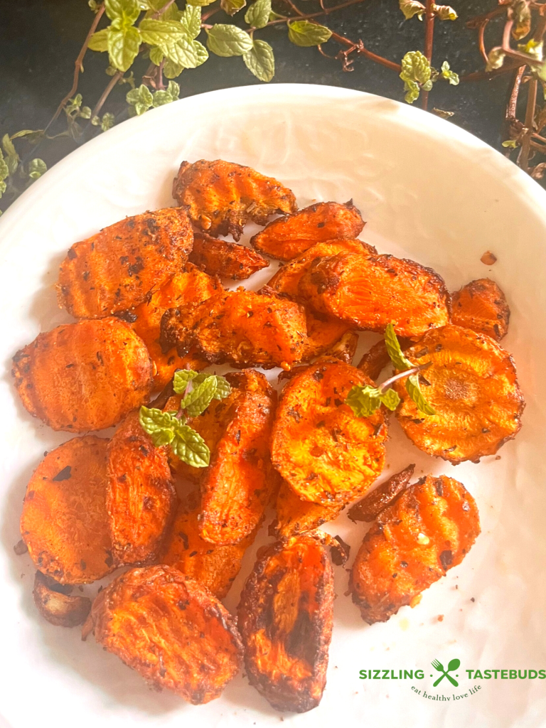 Garlic and Mint come together with carrots in this fuss free, Vegan + GF delicious dish that is made in minutes in an air fryer. Serve as a side or enjoy as a meal !