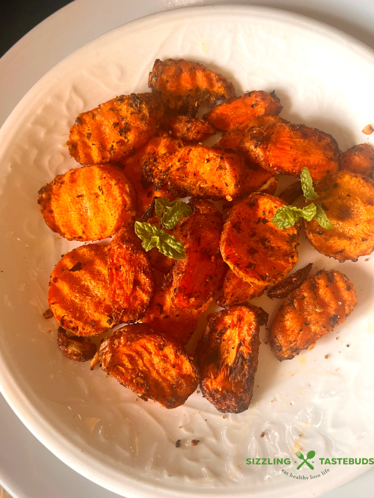 Garlic and Mint come together with carrots in this fuss free, Vegan + GF delicious dish that is made in minutes in an air fryer. Serve as a side or enjoy as a meal !