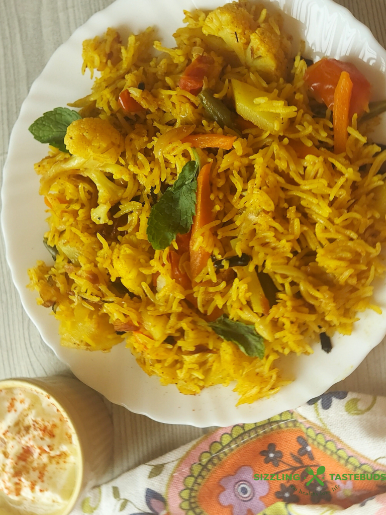 Let’s make this delicious and quick Pressure Cooker Veg Biryani that goes so well with raita / salad / papad for brunch or office / school lunchboxes too. Or a #potluck too !