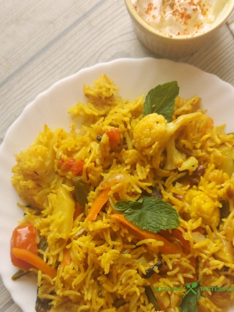Let’s make this delicious and quick Pressure Cooker Veg Biryani that goes so well with raita / salad / papad for brunch or office / school lunchboxes too. Or a #potluck too !