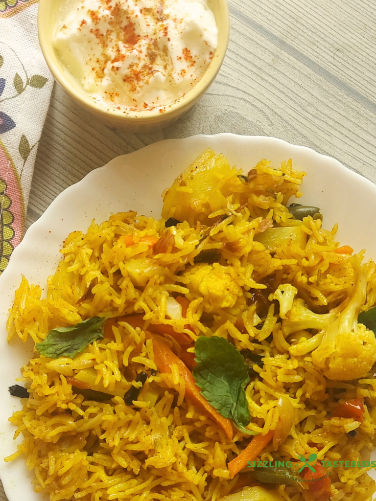 Let’s make this delicious and quick Pressure Cooker Veg Biryani that goes so well with raita / salad / papad for brunch or office / school lunchboxes too. Or a #potluck too !